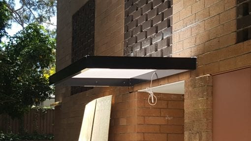 Slimline awning over a door way in to a block of units
