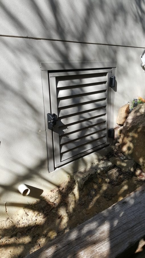 louver door for access under a house with a lock