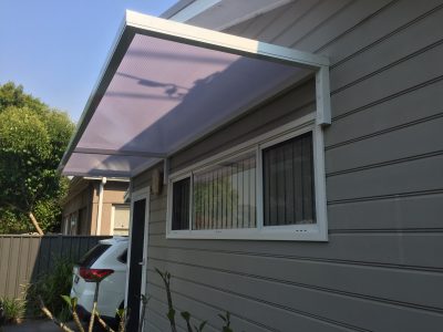 Slimline 50 Canter Lever awning with twin wall polycarb over a Door and window