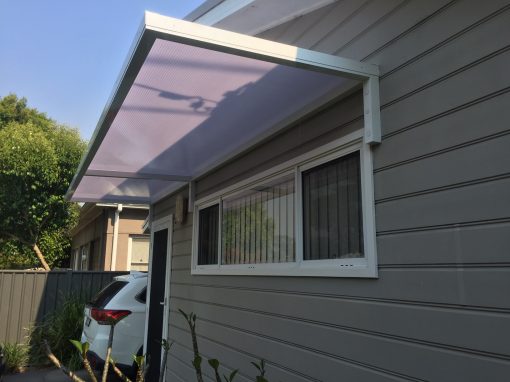 Slimline 50 Canter Lever awning with twin wall polycarb over a Door and window